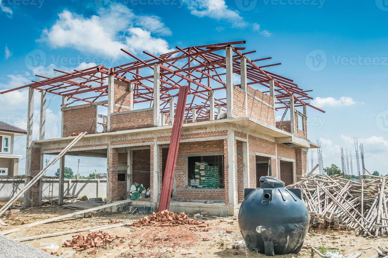 house building structure at construction site with clouds and blue sky photo