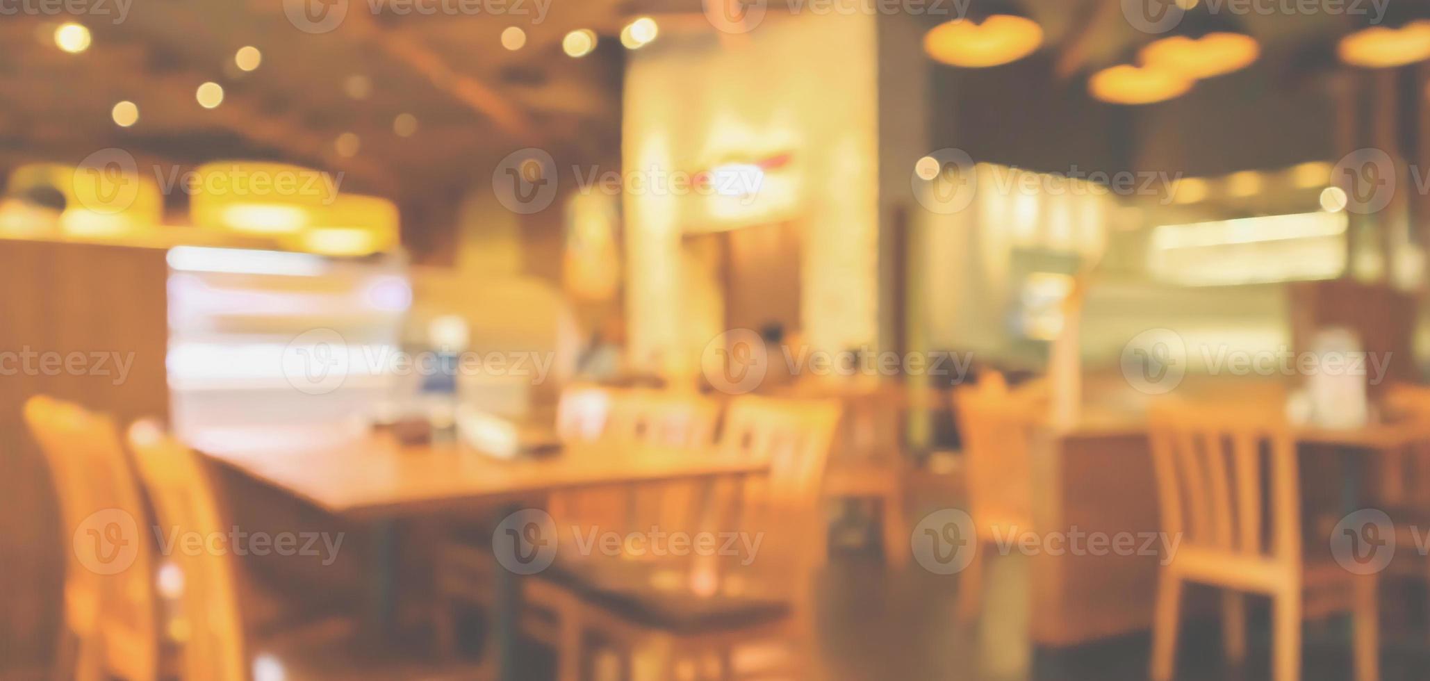 Restaurant interior with customer and wood table blur abstract background with bokeh light photo