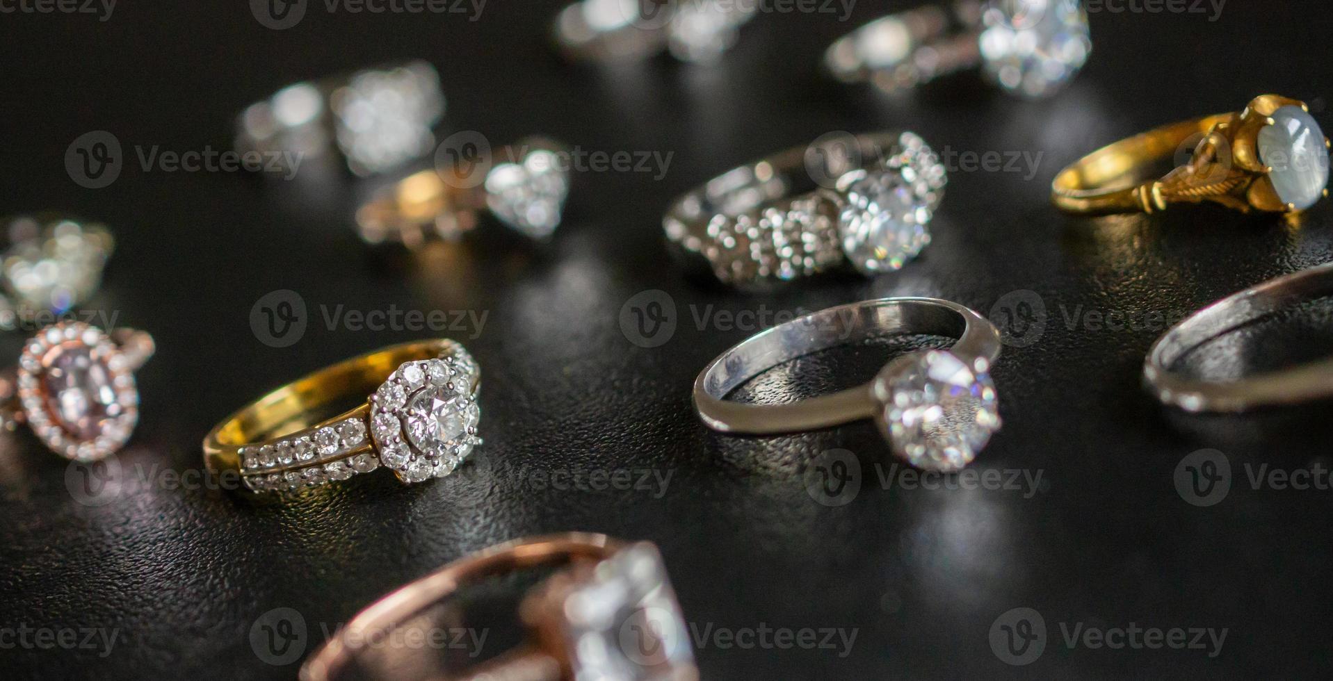 Jewelry diamond rings set on black background close up photo