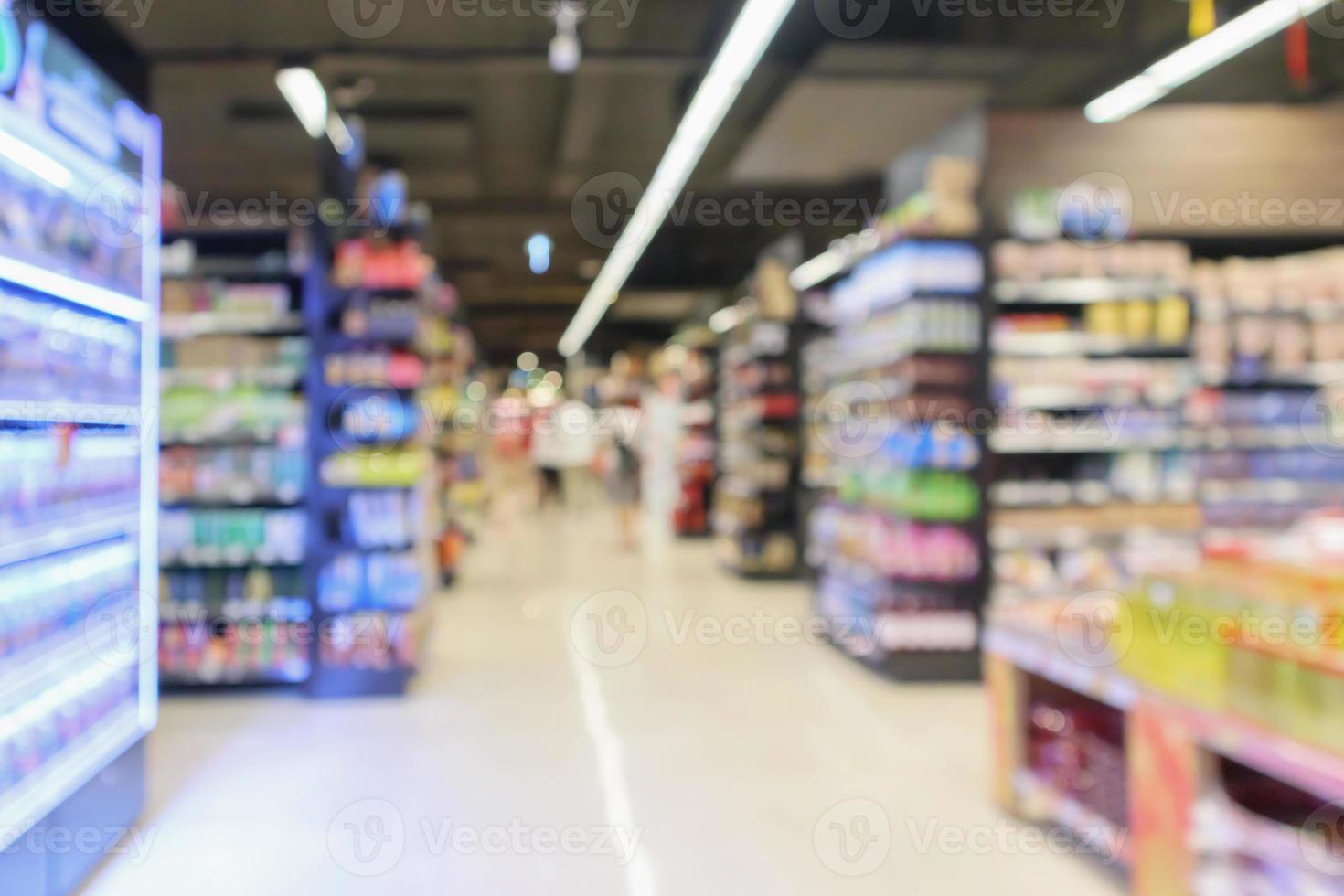 supermarket aisle with product shelves interior defocused blur background photo