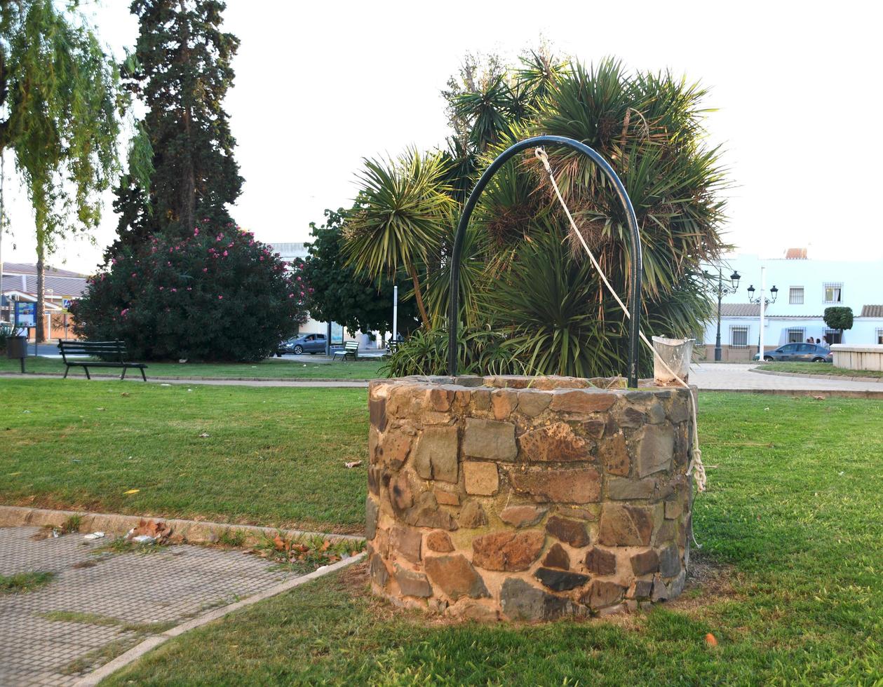 Stone well in the garden photo