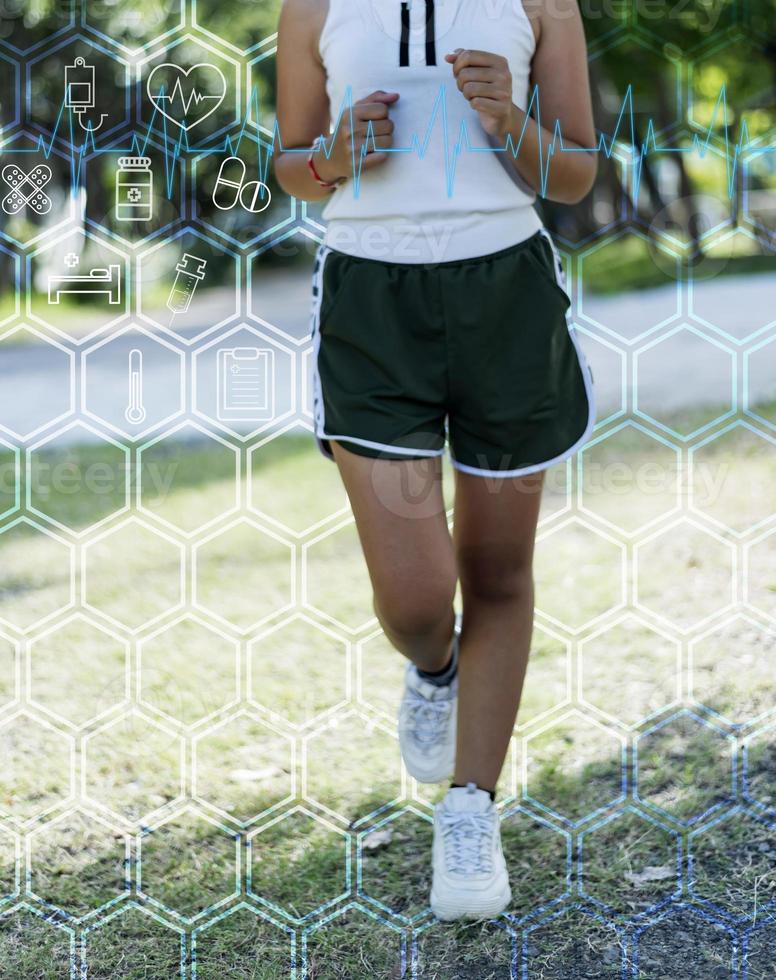 Sporty woman runner in shadow on a natural background, Women are jogging to maintain a healthy body. Technological concepts of running for good health. photo