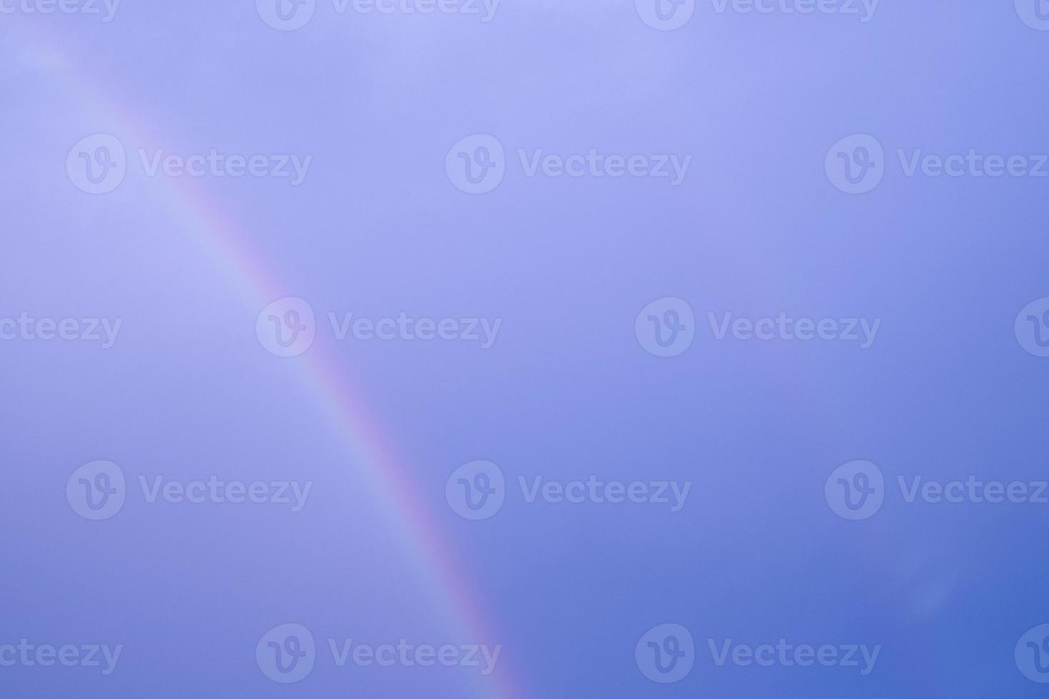 curve multi color double rainbow on blue sky. abstract pastel light on hogh air on climate after rain fallen. photo