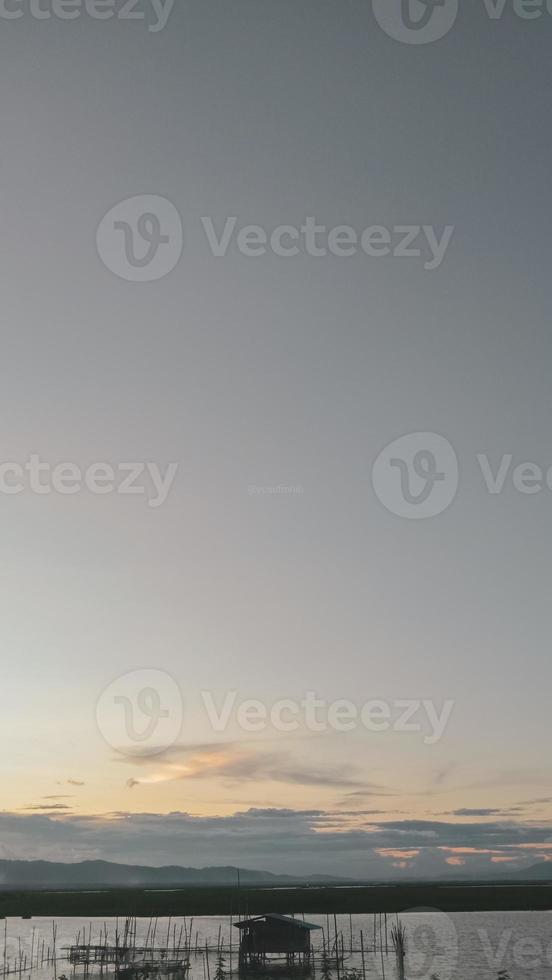 Silhouette of a man fishing in the afternoon. sunset on lake Limboto, Indonesia photo