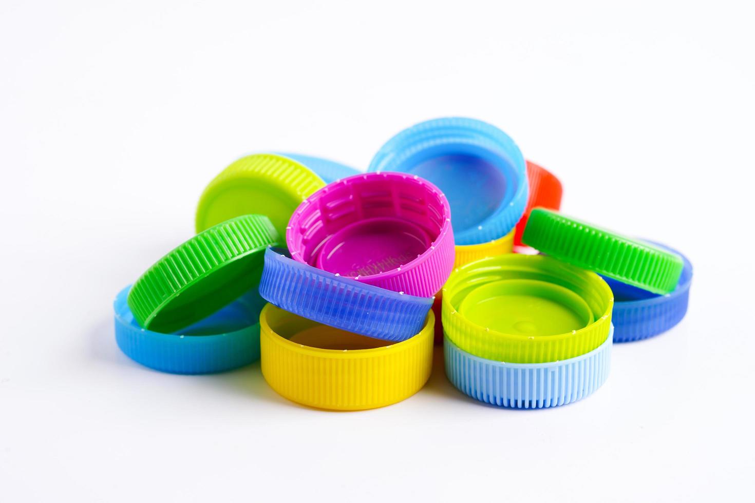 Plastic bottle caps colorful for recycle on white background. photo