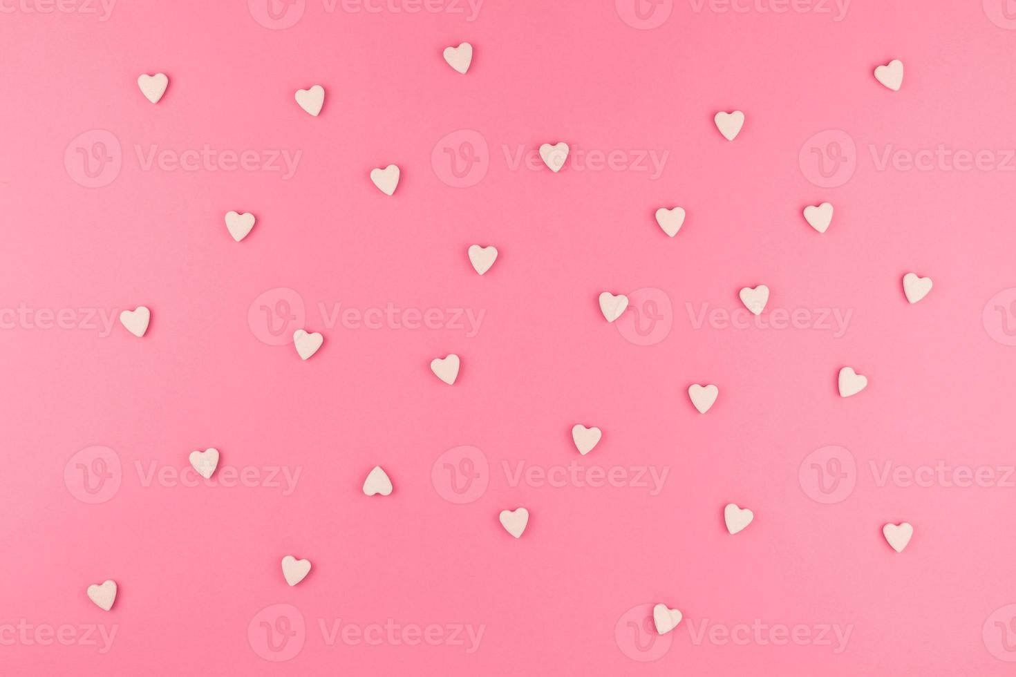 Flat lay of pink heart shaped candies photo