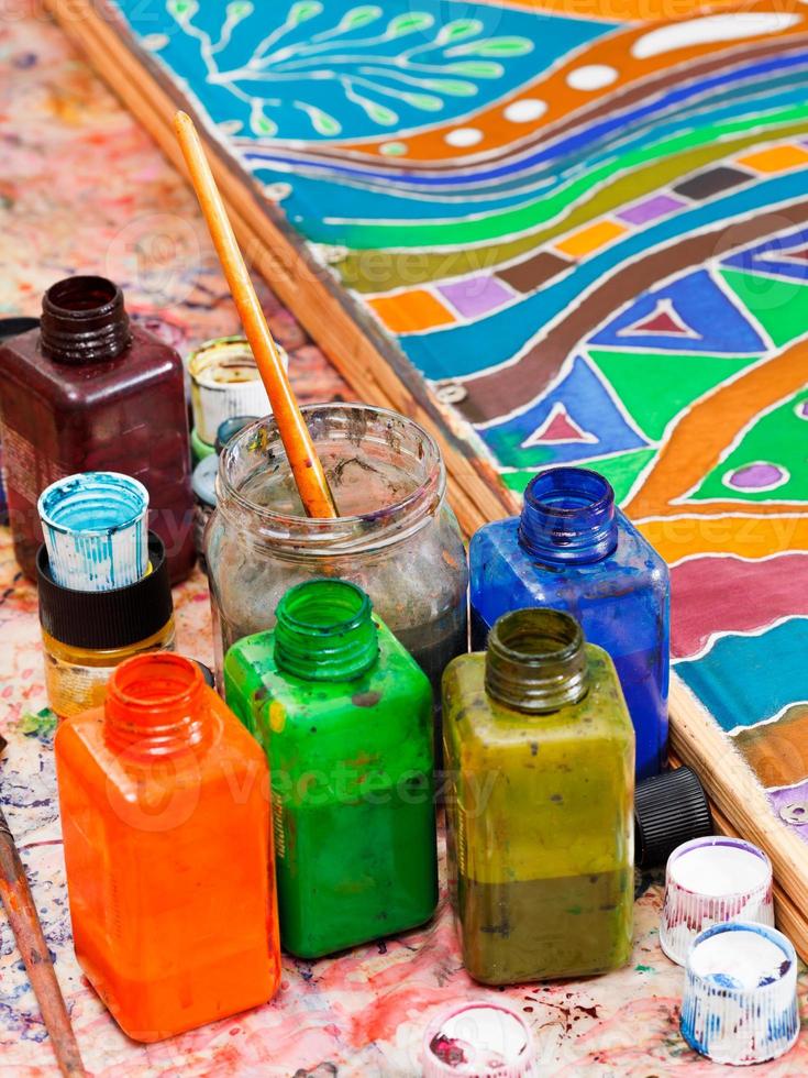 paintbrushes and bottles with pigments photo