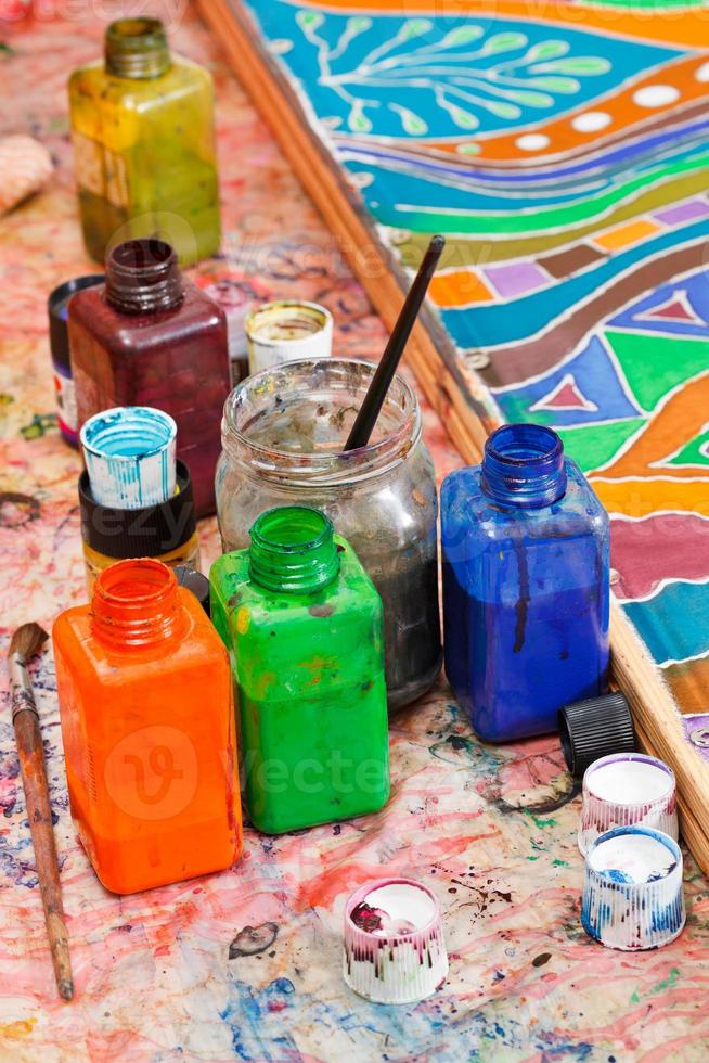 paintbrushes, bottles with color pigments photo