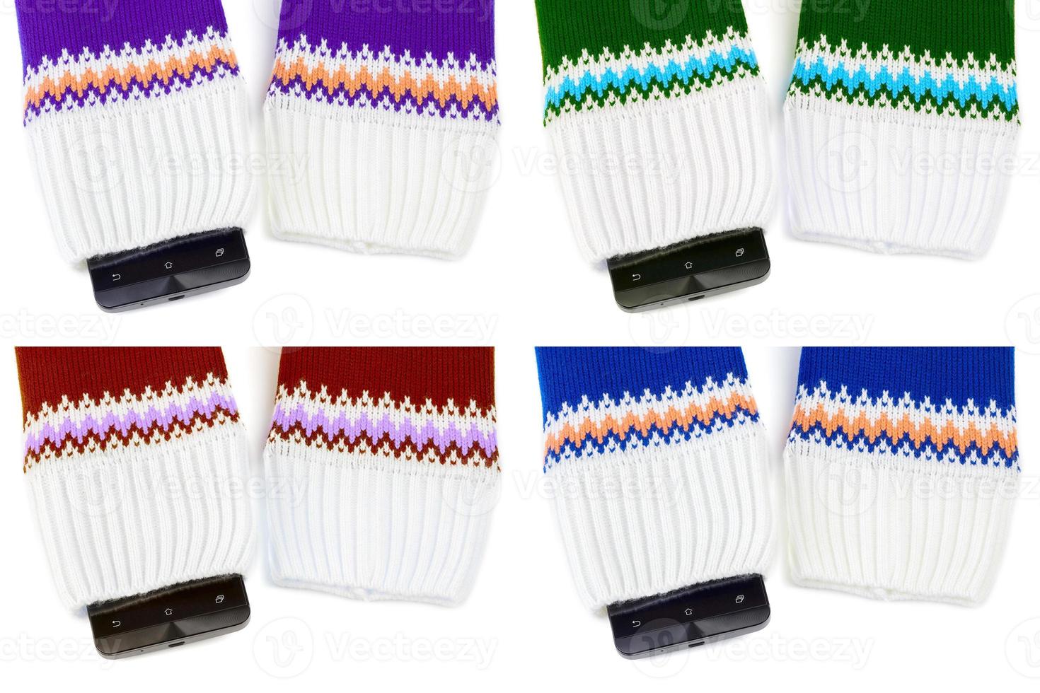 cellphone sticking out from knitted fabric like sweater or mittens photo