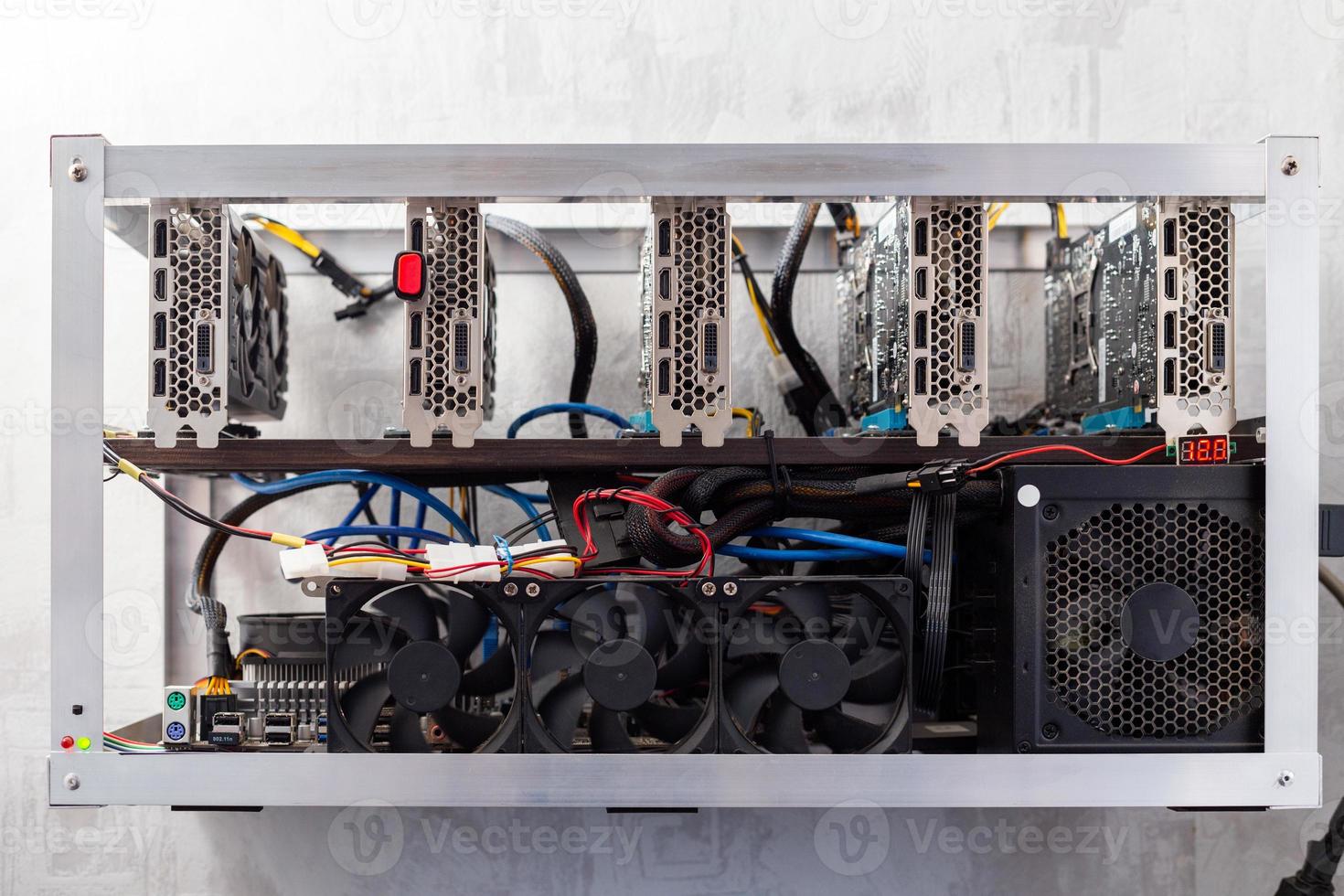 domestic gpu cripto mining rig on wall with selective focus photo