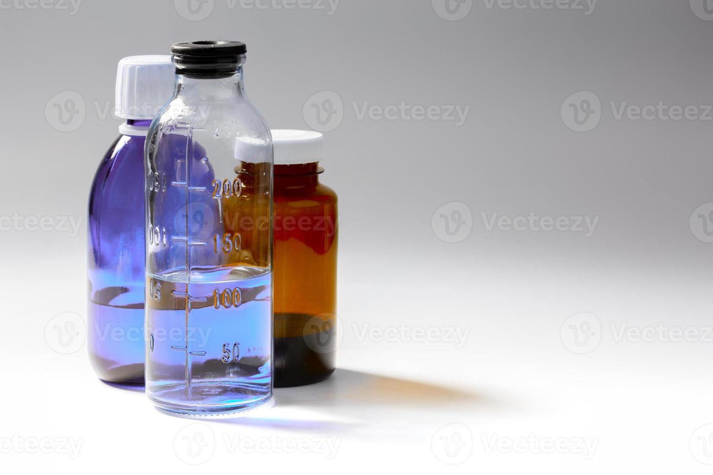 colored medial bottles on gray background with copyspace photo