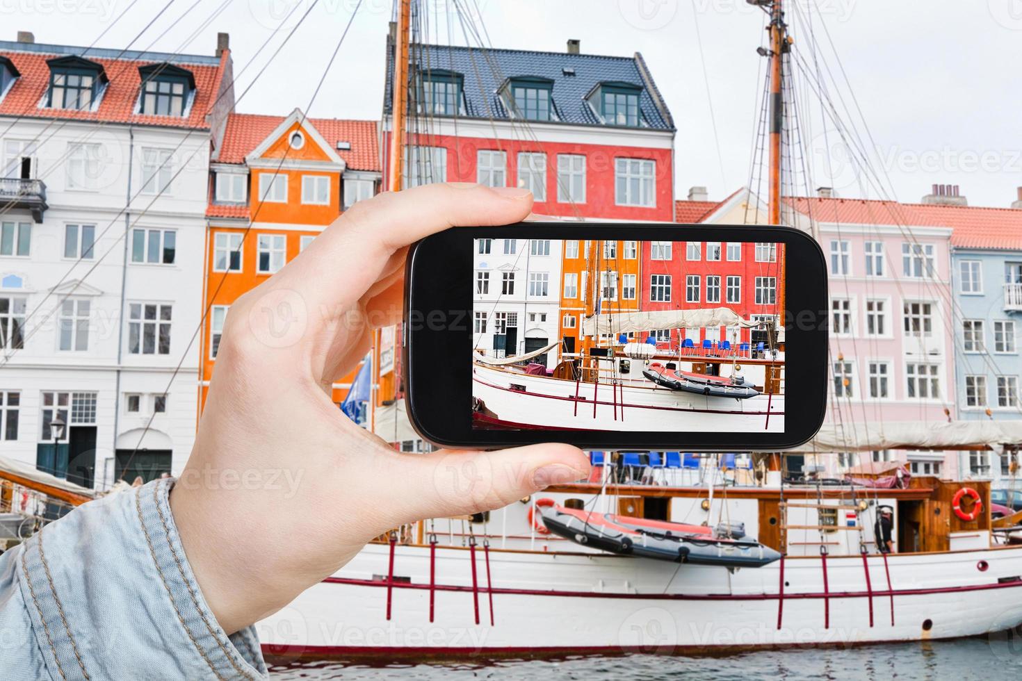 tourist taking photo of Nyhavn waterfront