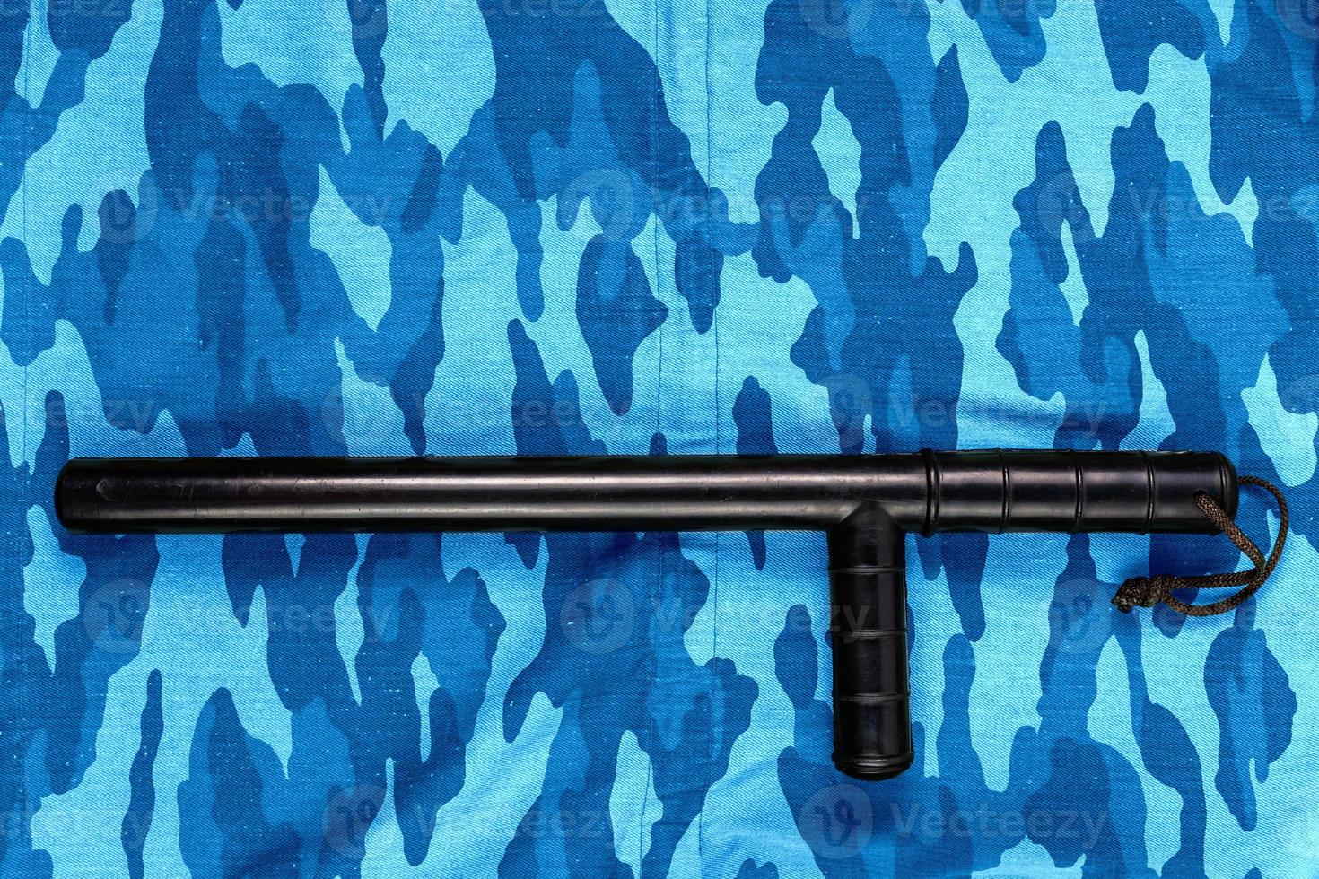 black rubber baton on blue urban russian riot police camouflage flat lay photo