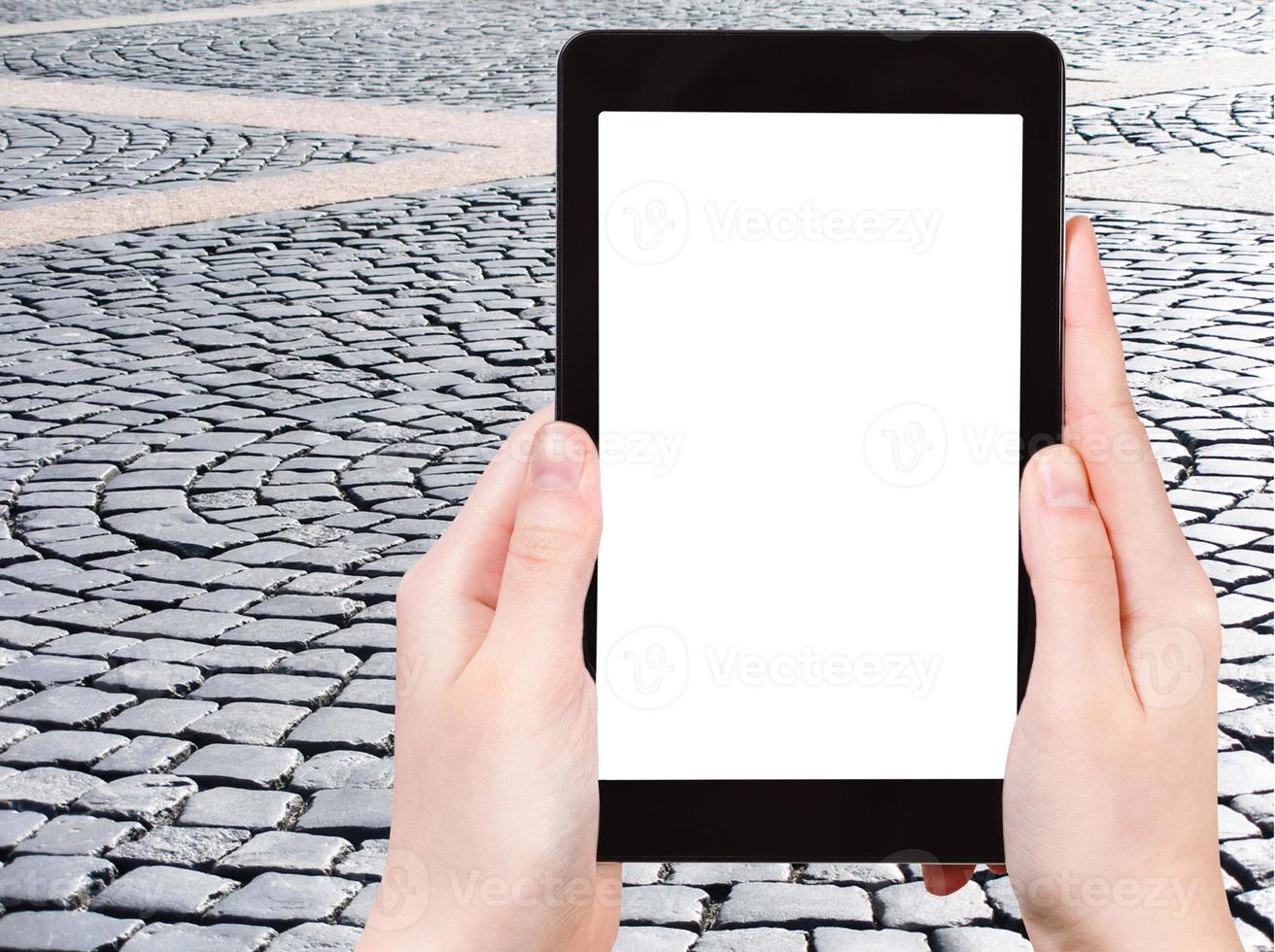 tourist photographs cobblestone pavement photo