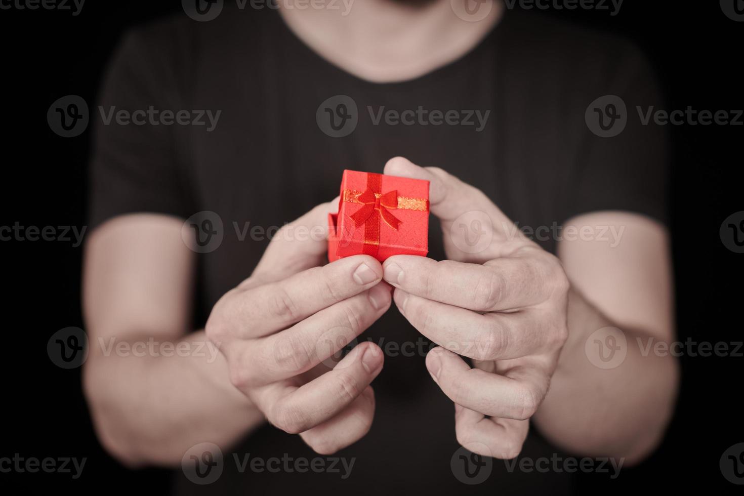 Man give a gift in red gift box on St. Valentine day photo