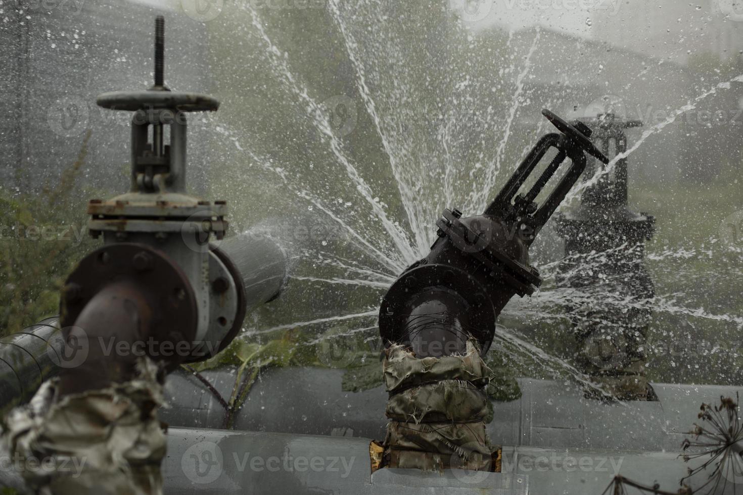 Pipe valve failure. Flow of boiling water. Steel pipe broke. Emergency. Pipeline accident. photo