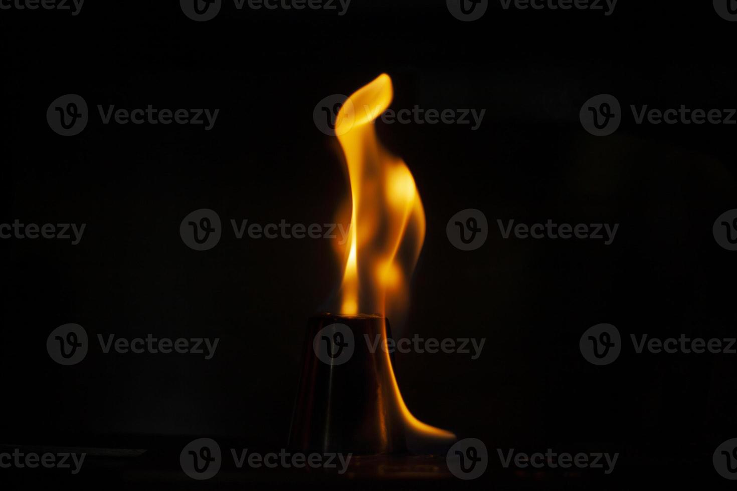 Flames in dark. Tongue of fire one. Alcohol flame retardation. photo