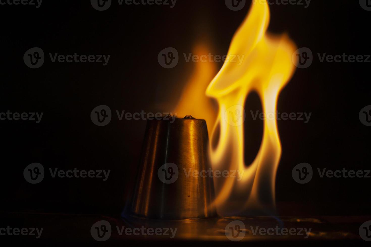 Flames in dark. Tongue of fire. Ignition of alcohol. Burning alcohol on black background. photo