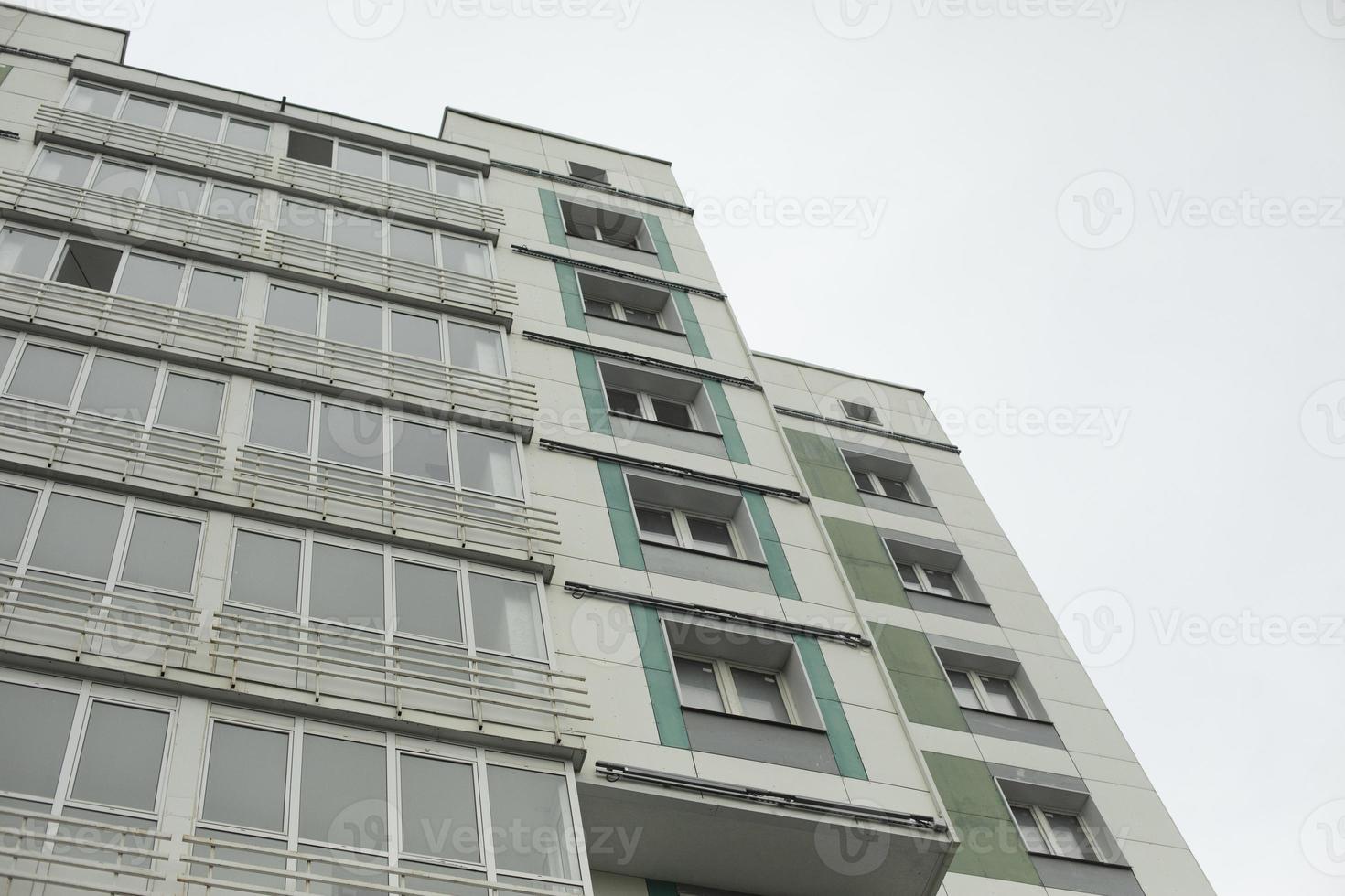 Building in city. Architecture details. Lots of windows in house. photo