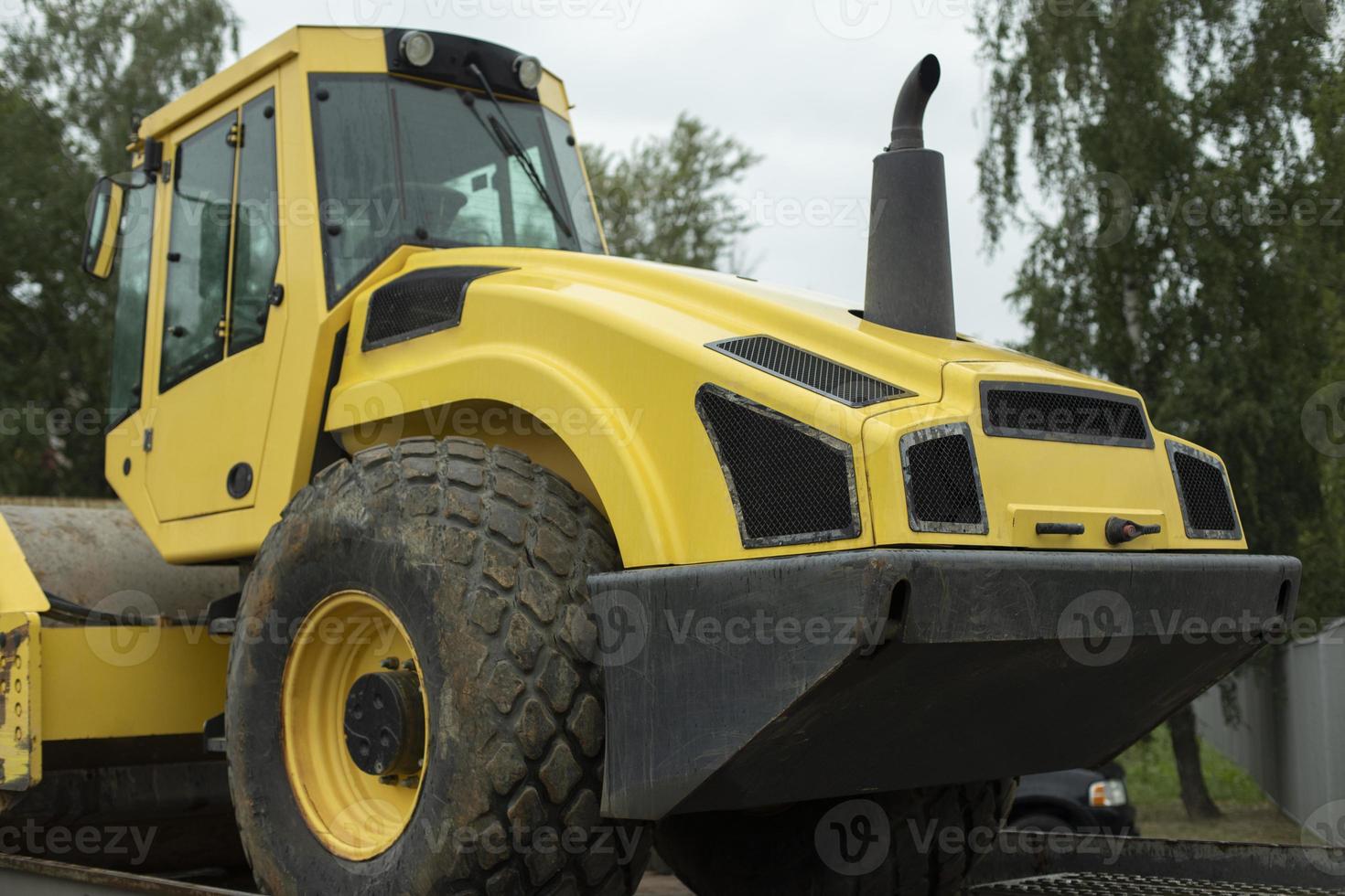 Transportation on platform of heavy machinery. Yellow tractor. 12612385