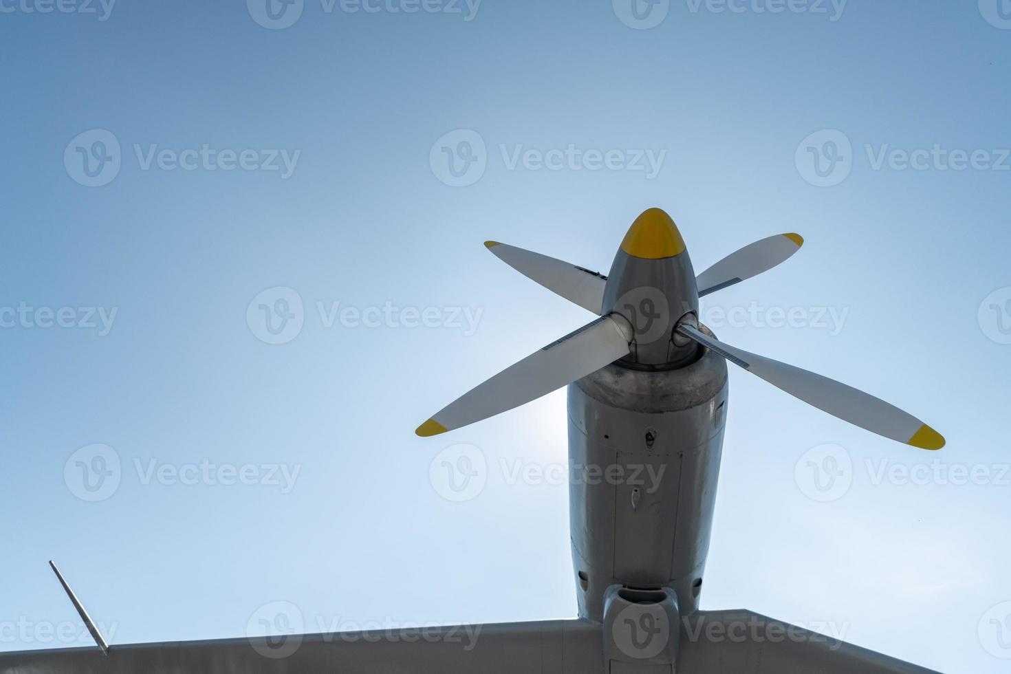 Airplane propeller of military aircraft, copy space. Blue sky background. photo