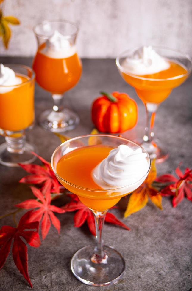 Pumpkin fall seasonal drink cocktail latte with spices and whipped cream for Thanksgiving or Halloween party festive celebrate. Autumn decoration photo