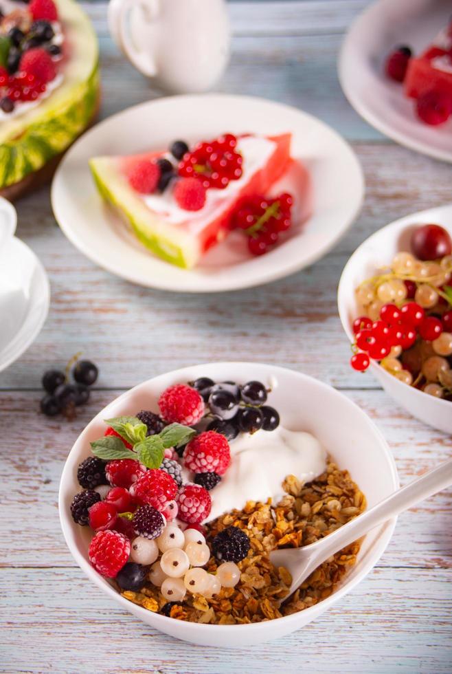 Granola, muesli cereals with yogurt or milk and fresh berries. Healthy breakfast concept. photo