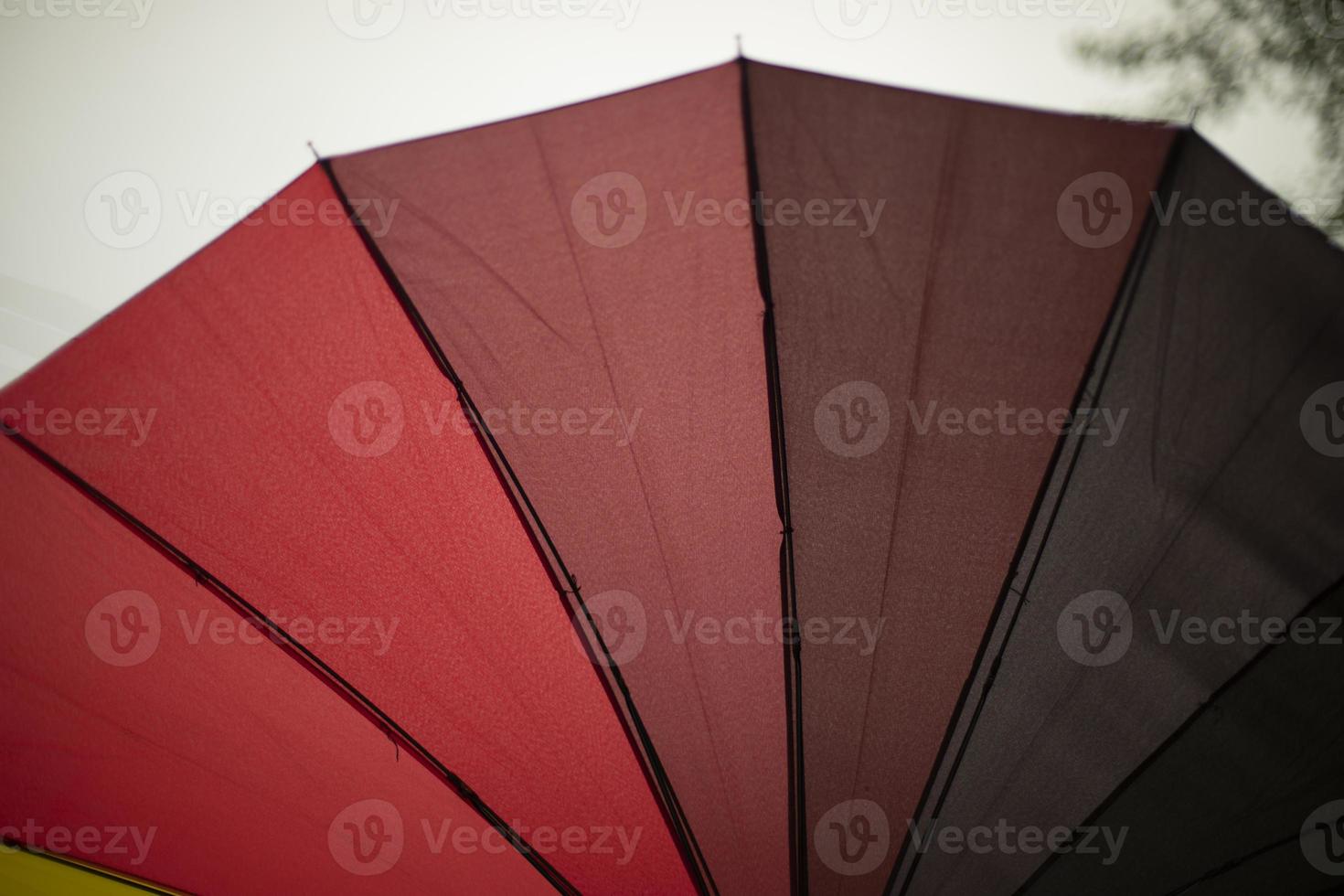 Red umbrella from rain. Red gradient. Umbrella needles and fabric. photo