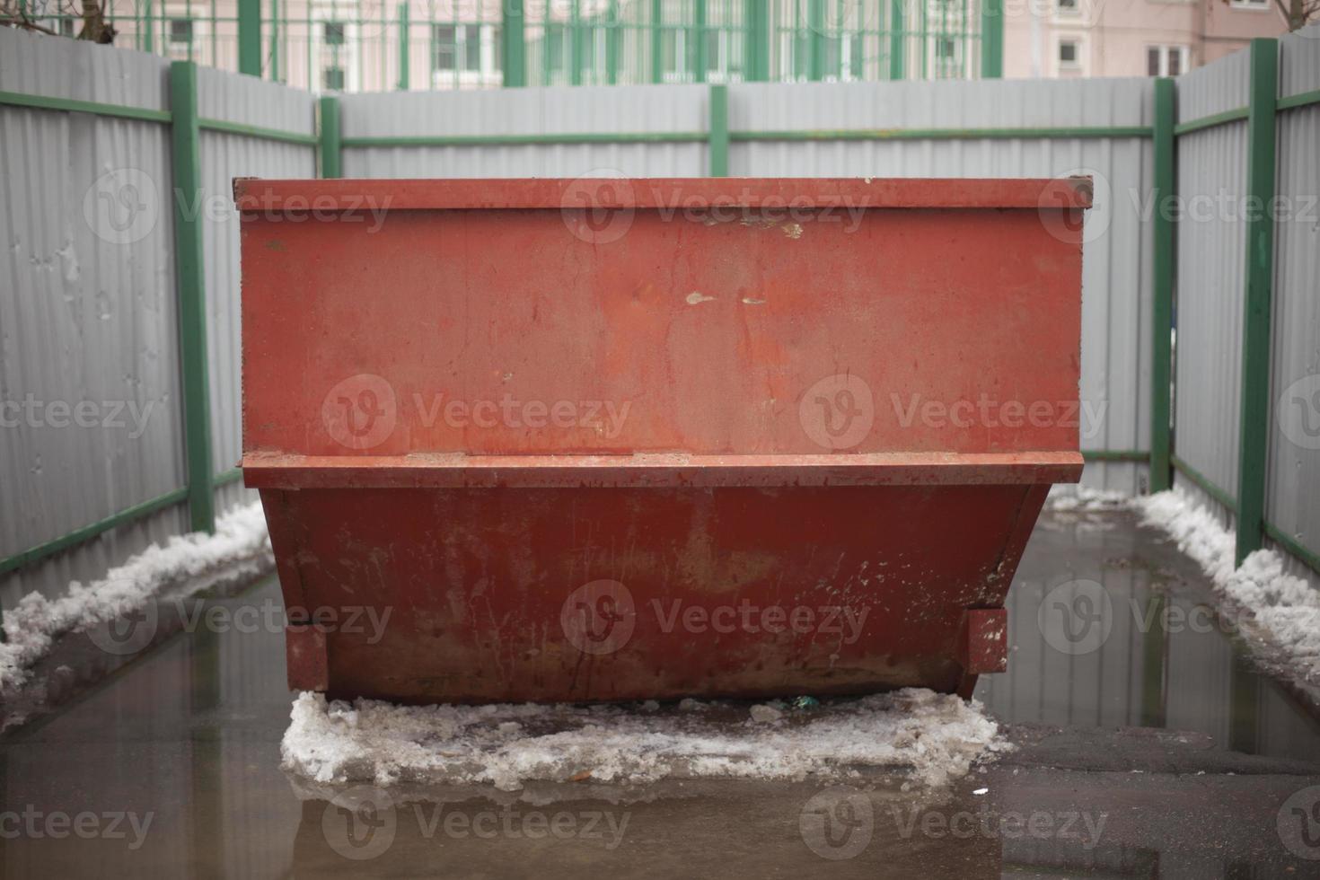 Garbage container. Steel waste tank in city. Large garbage can in yard. photo