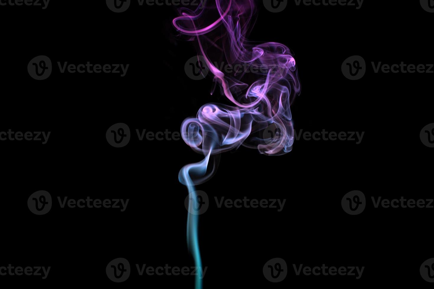 Multicolored smoke for aromatherapy relaxation on black background, beautiful swirled puffs of smoke photo