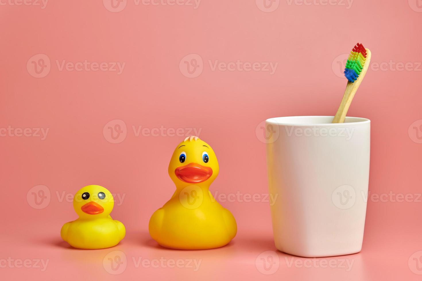 Eco bamboo toothbrush and duck toys. Personal care tool for protect oral cavity, remove plaque and tartar. photo