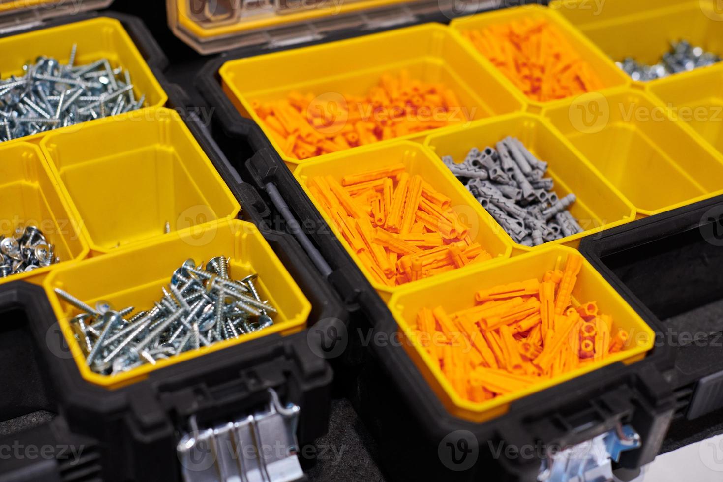 Storage case with screws, nuts, bolts, nails and other small tools for handyman, close up photo