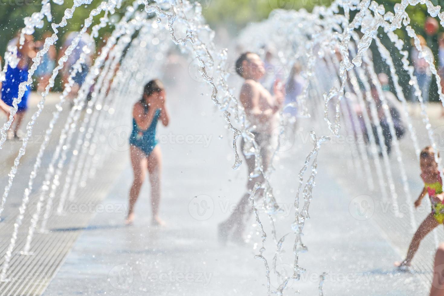 Children play in dry fountain photo