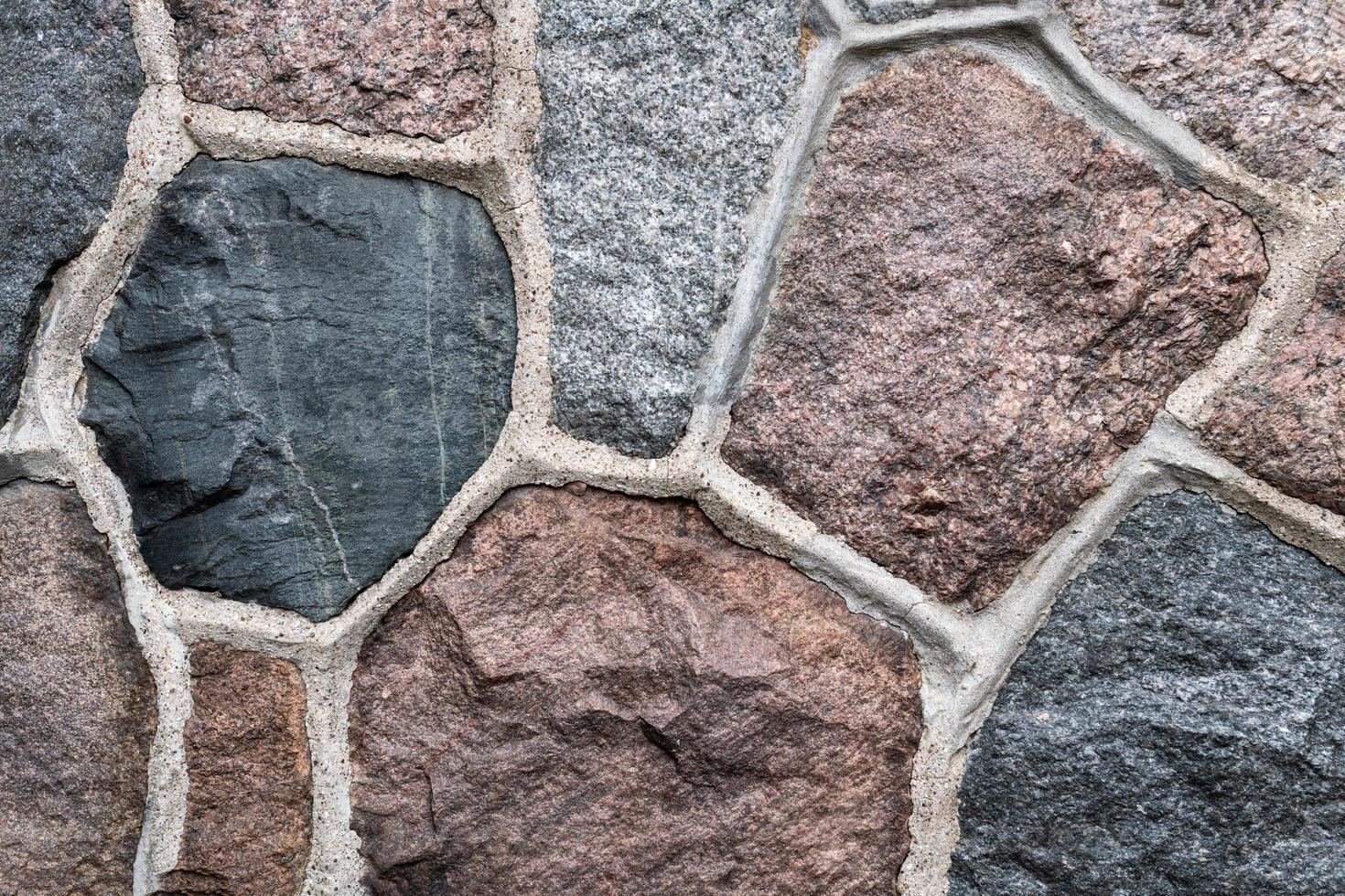 Masonry stone abstract texture on ancient foundation of cathedral. Old tile pattern. photo