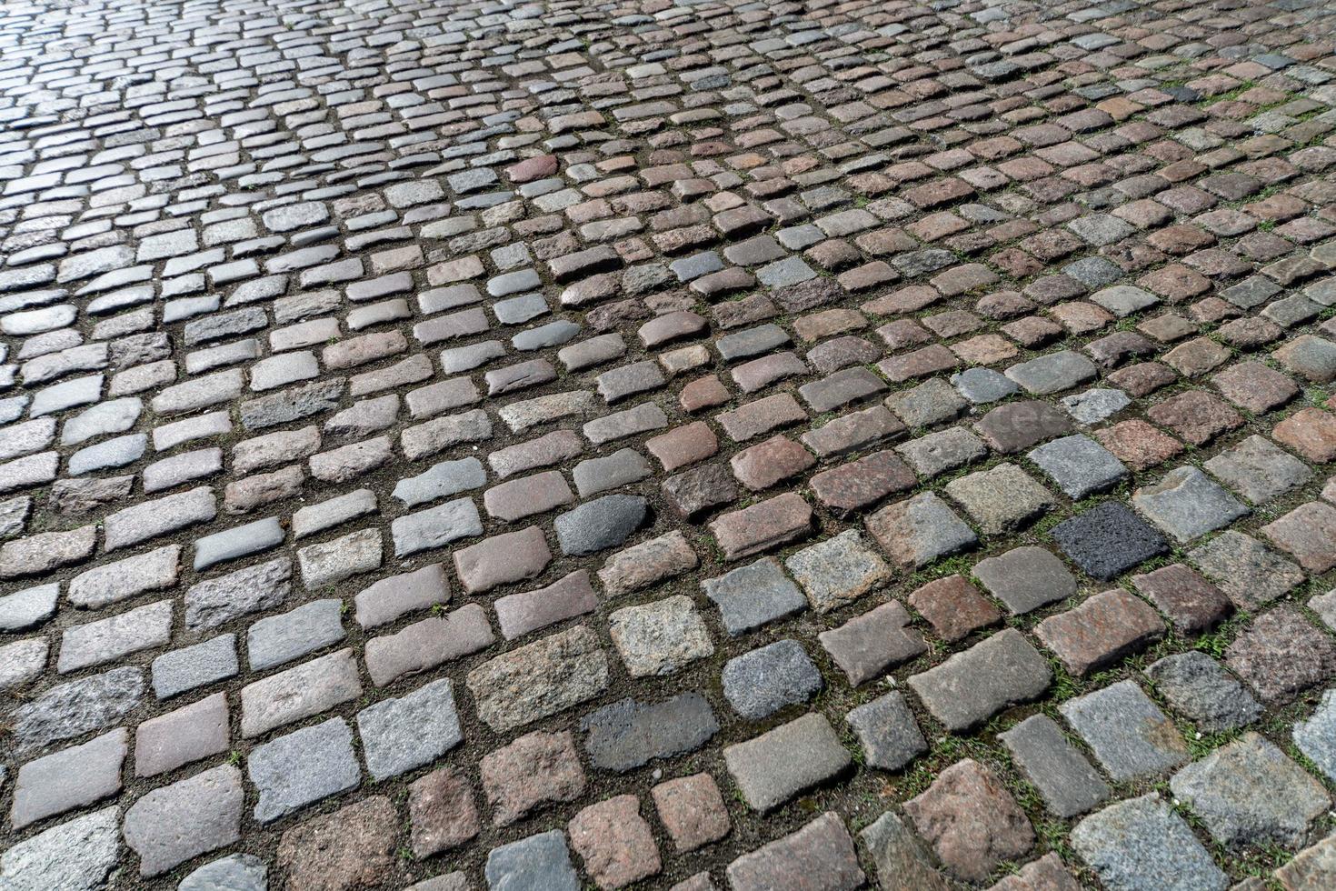 Old paving stones pattern. Texture of ancient german cobblestone in city downtown. Little granite tiles. Antique gray pavements. photo