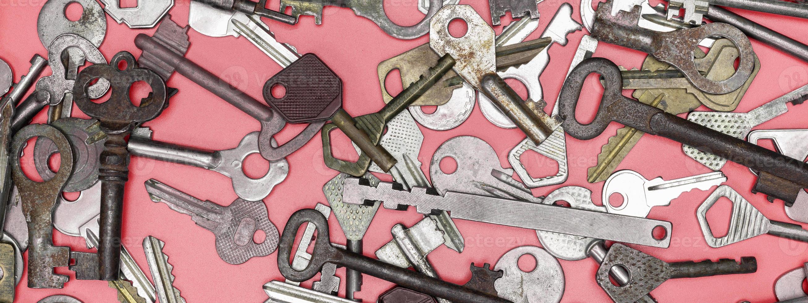 Keys set on pink background. Door lock keys and safes for proper photo
