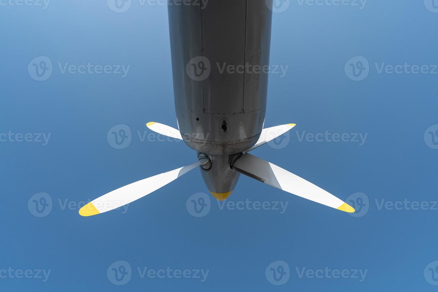 Airplane propeller of military aircraft, copy space. Blue sky background. photo