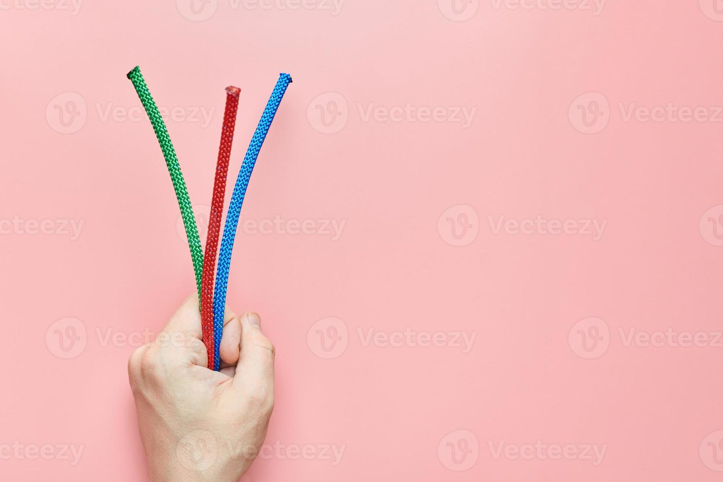 Braided nylon ropes in hand, copy space photo
