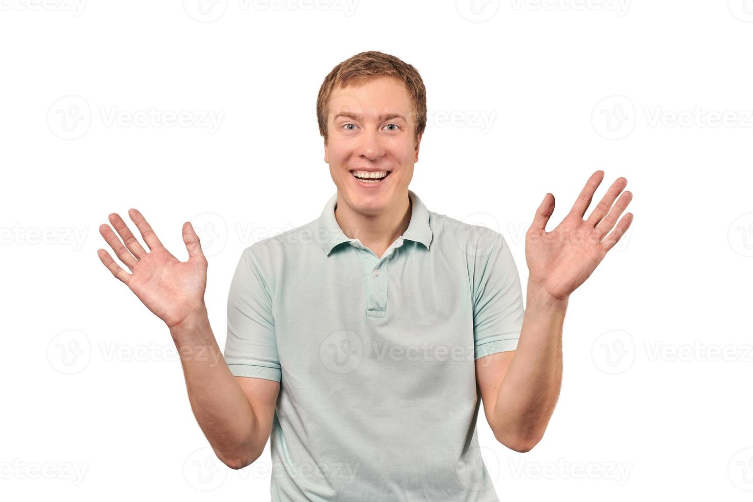 Funny smiling man in T-shirt showing palms of hands, unexpected surprise gesture, white background photo