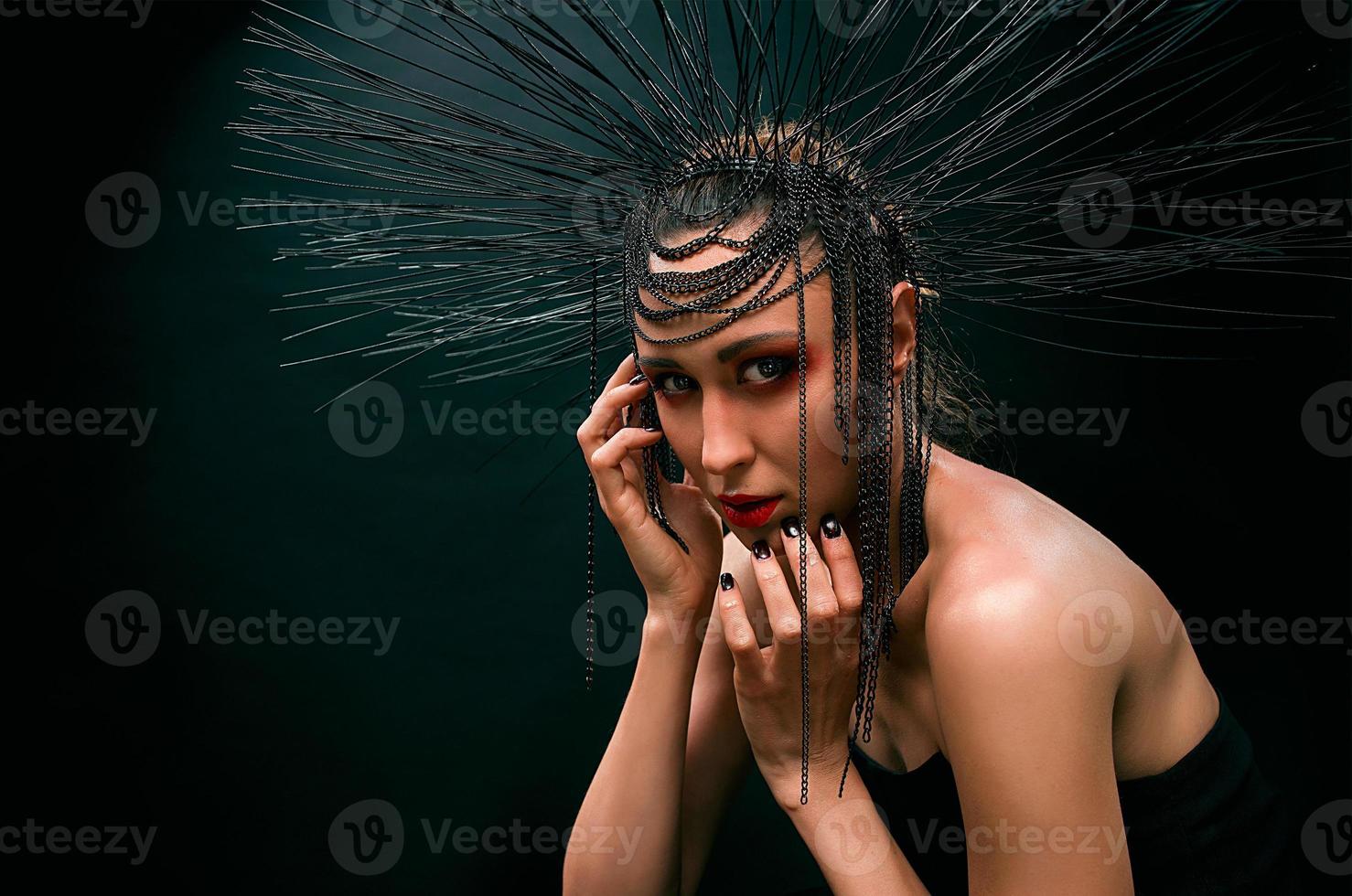 portrait of young beautiful woman like witch with red lips and black crown on dark background. Black dark beauty, Halloween concept photo