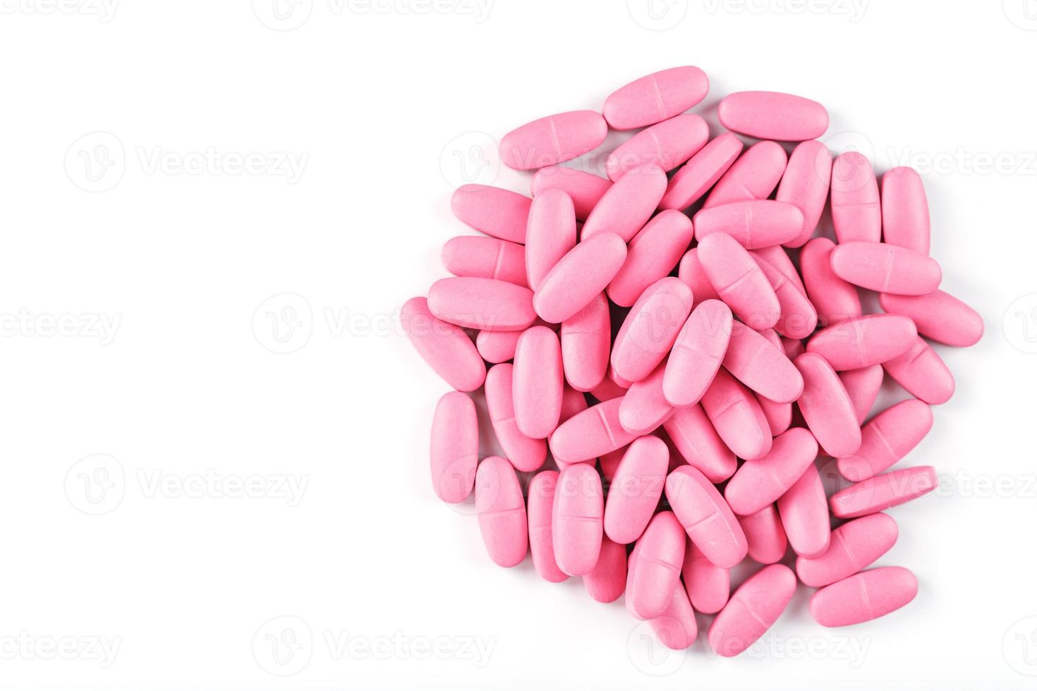 pastillas de vitamina rosa para mujeres de fondo blanco. foto