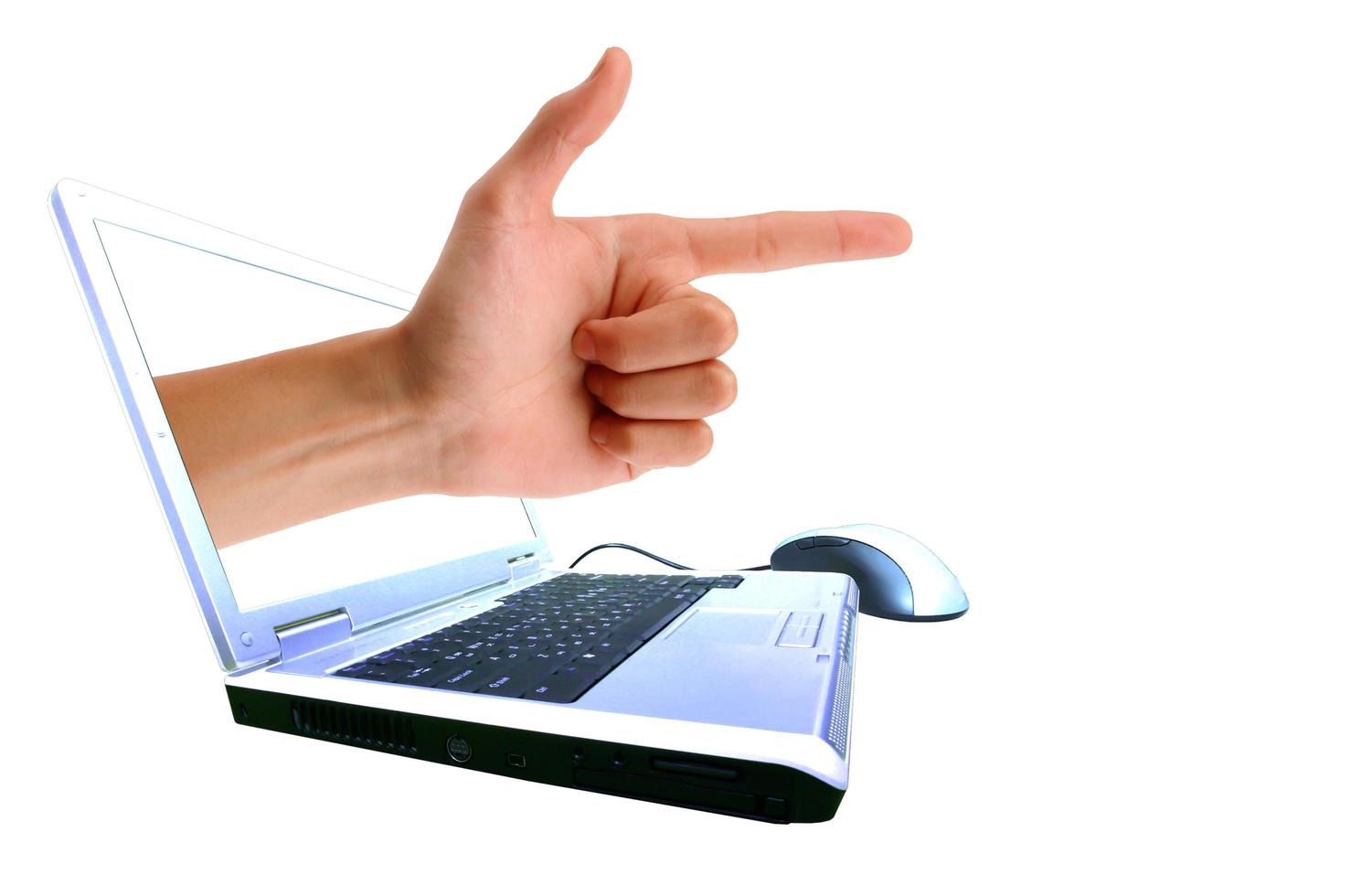 A hand giving everyone through a laptop. Isolated on a white background photo