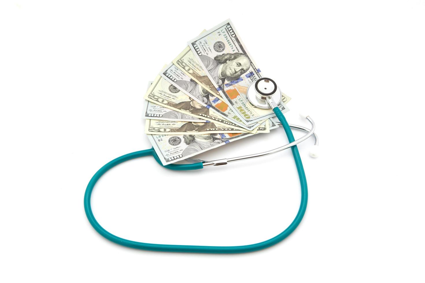 Stack of coins and money and stethoscope photo