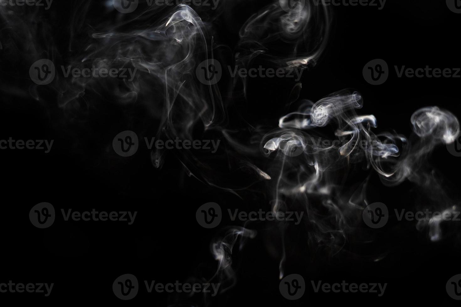 White smoke on black background for layer overlay effect. A realistic smoke or fog effect for photo and video manipulation effect and mystery design theme