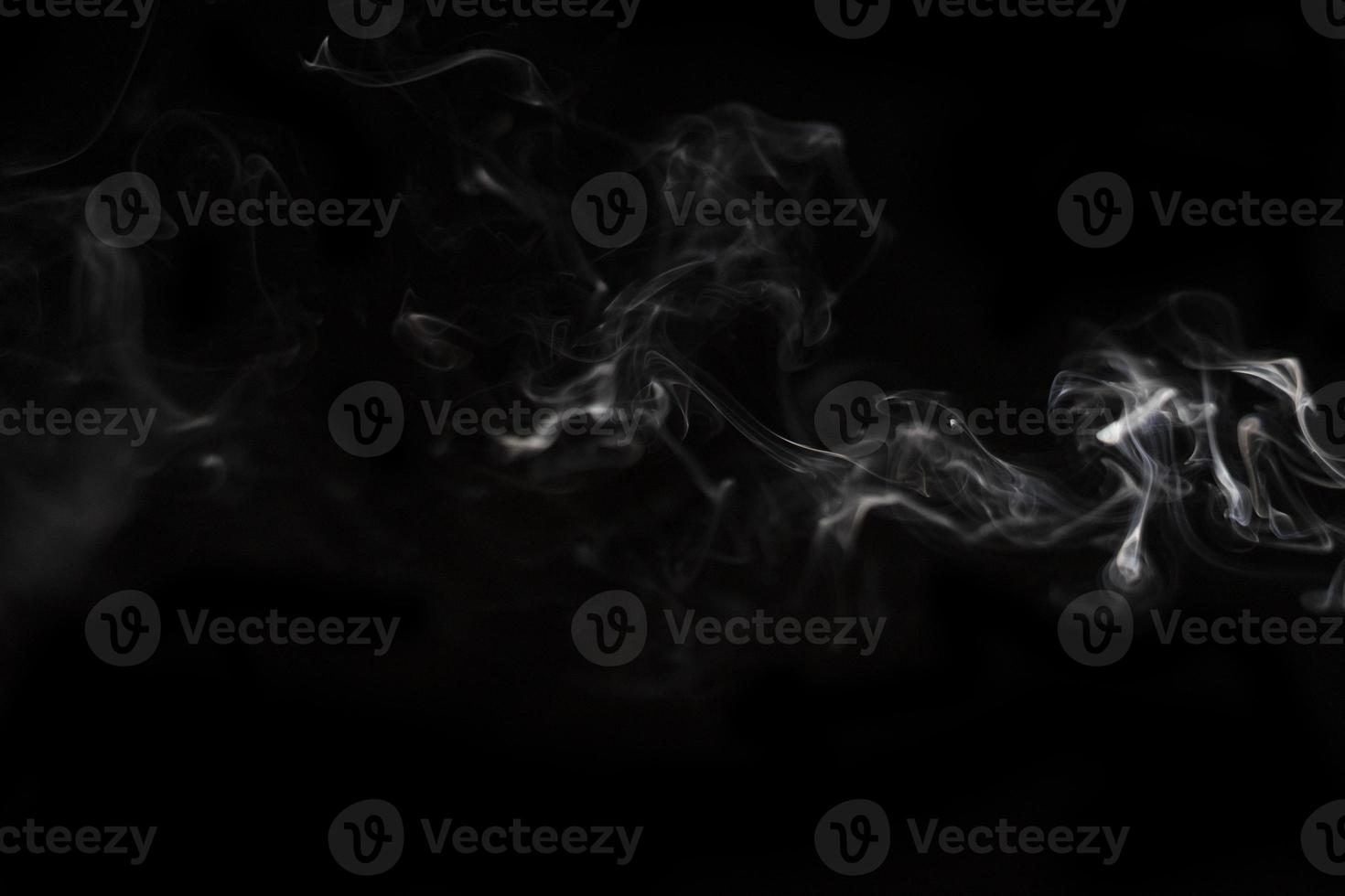 White smoke on black background for layer overlay effect. A realistic smoke or fog effect for photo and video manipulation effect and mystery design theme