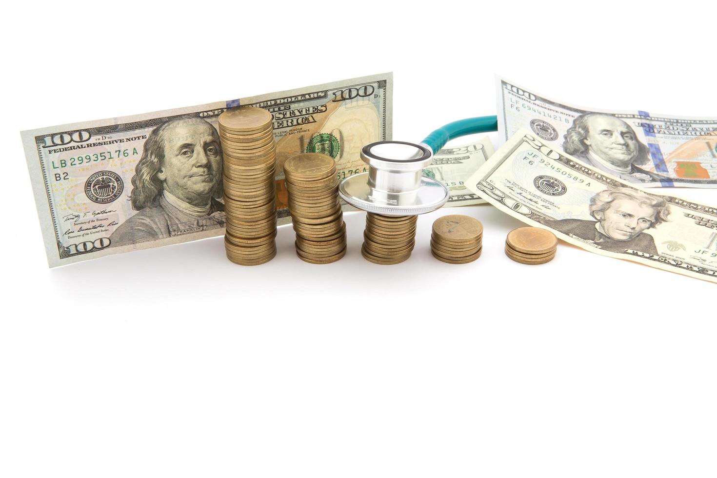 Stack of coins and money and stethoscope photo