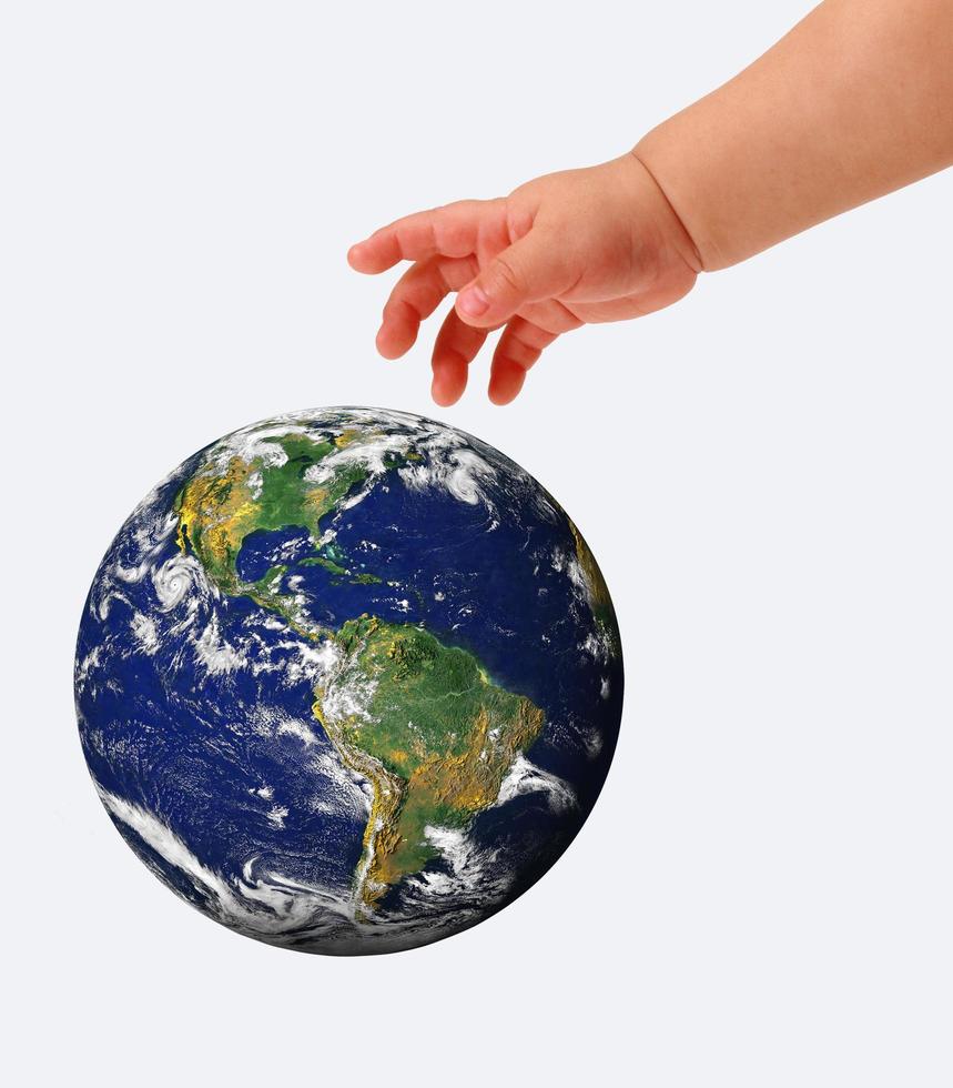 The globe in hands of the child,isolated on a white photo