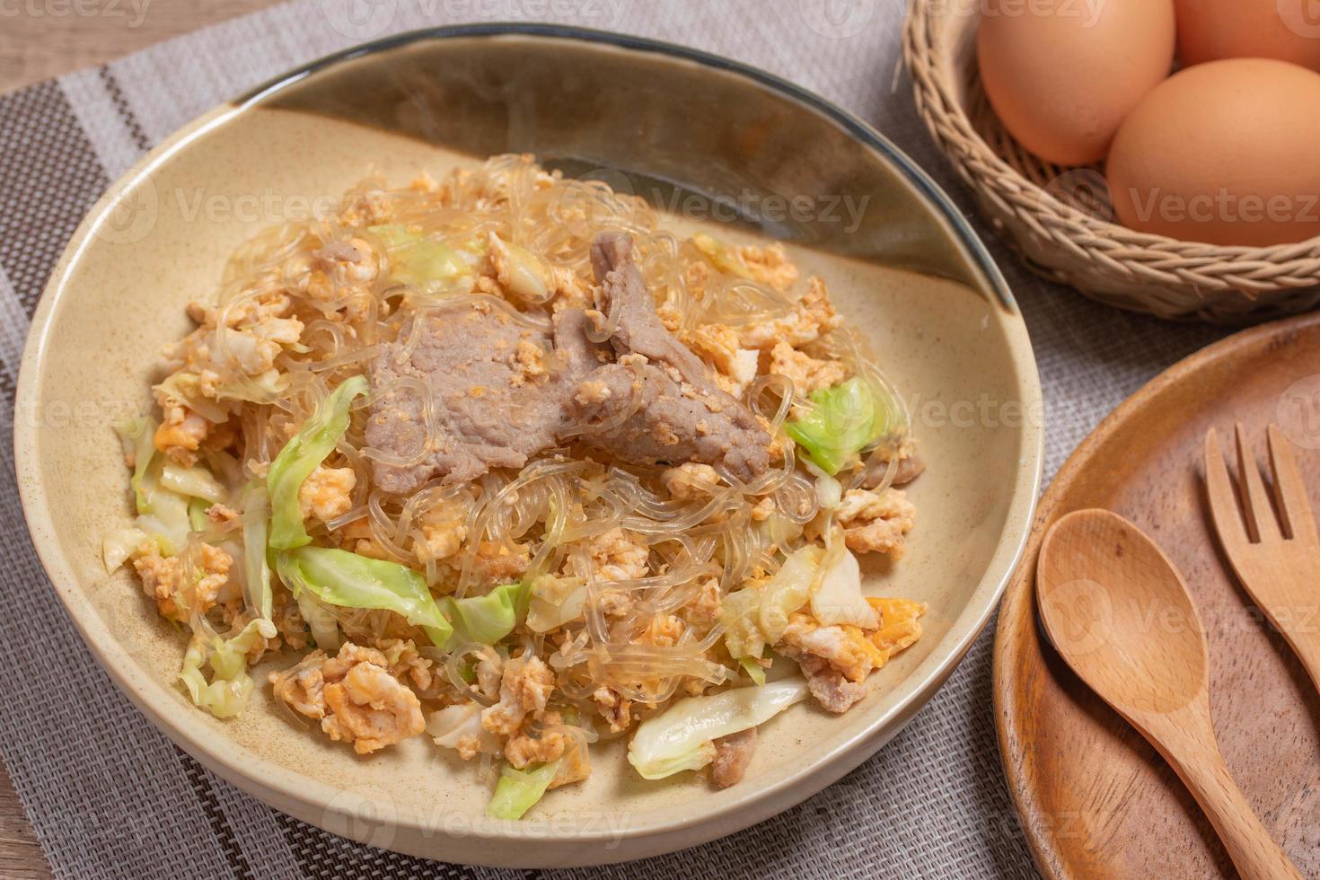 Stir fried vermicelli with pork, egg and collard greens in a white