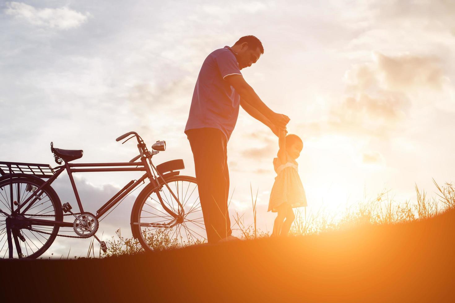 father and son having fun on sunset photo