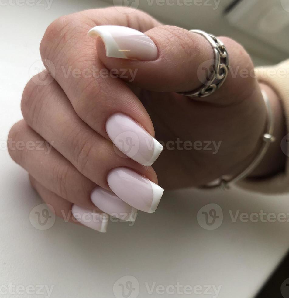 French manicure on the nails. French manicure design. Manicure gel nail polish photo